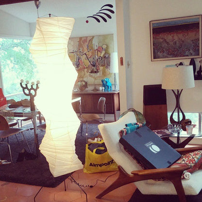 "Minimalist rice paper floor lamp with sleek metal frame and soft diffused light, perfect for creating a warm ambiance."