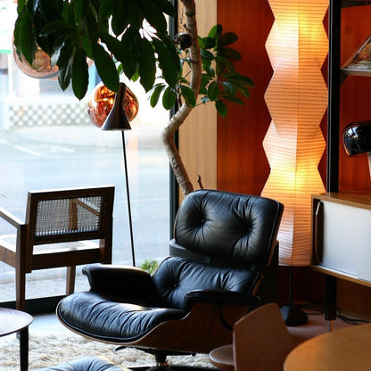"Minimalist rice paper floor lamp with sleek metal frame and soft diffused light, perfect for creating a warm ambiance."