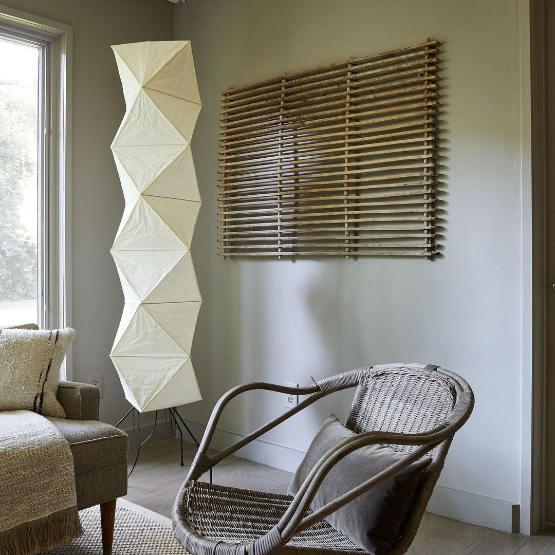 "Minimalist rice paper floor lamp with sleek metal frame and soft diffused light, perfect for creating a warm ambiance."