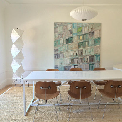 "Minimalist rice paper floor lamp with sleek metal frame and soft diffused light, perfect for creating a warm ambiance."