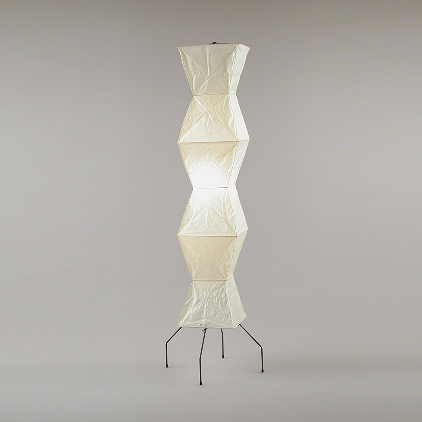 "Minimalist rice paper floor lamp with sleek metal frame and soft diffused light, perfect for creating a warm ambiance."
