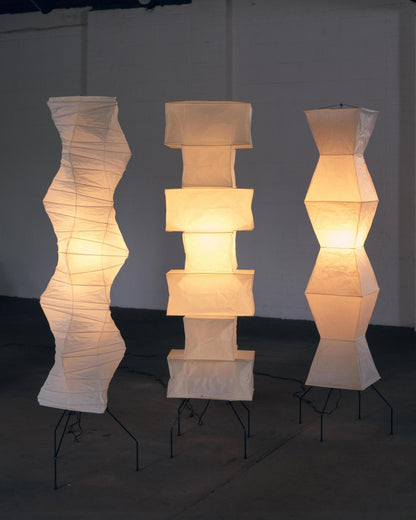 "Minimalist rice paper floor lamp with sleek metal frame and soft diffused light, perfect for creating a warm ambiance."