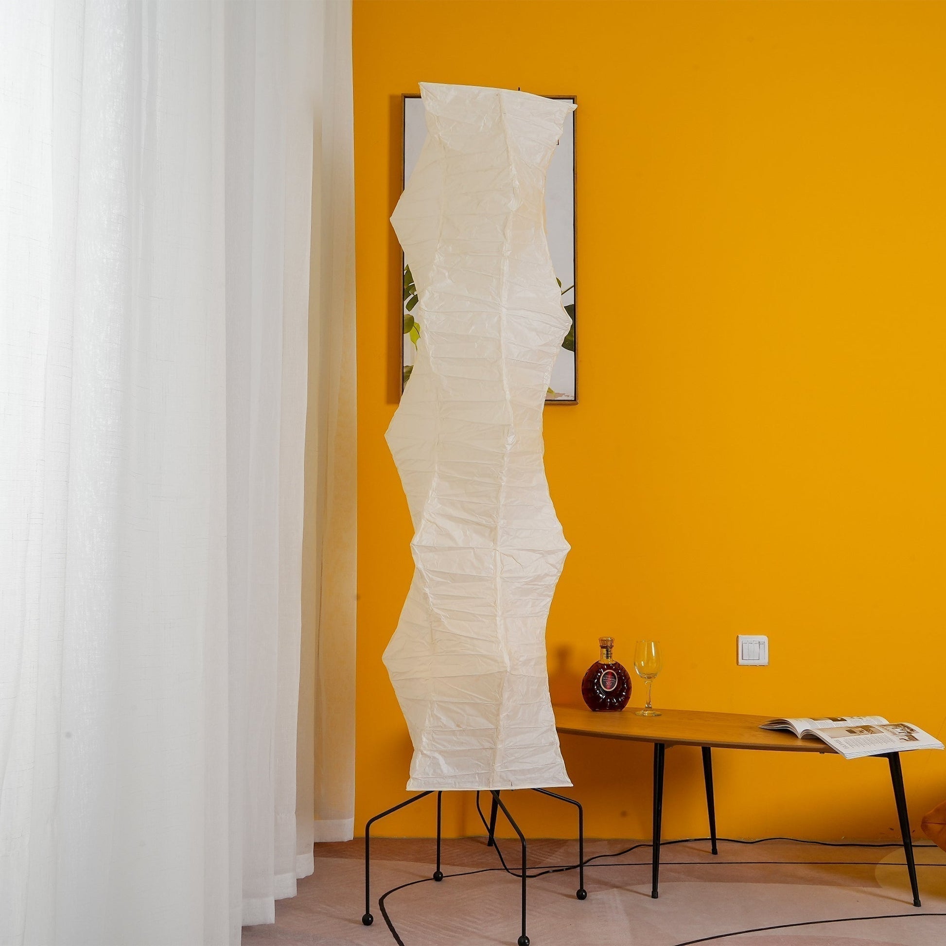 "Minimalist rice paper floor lamp with sleek metal frame and soft diffused light, perfect for creating a warm ambiance."
