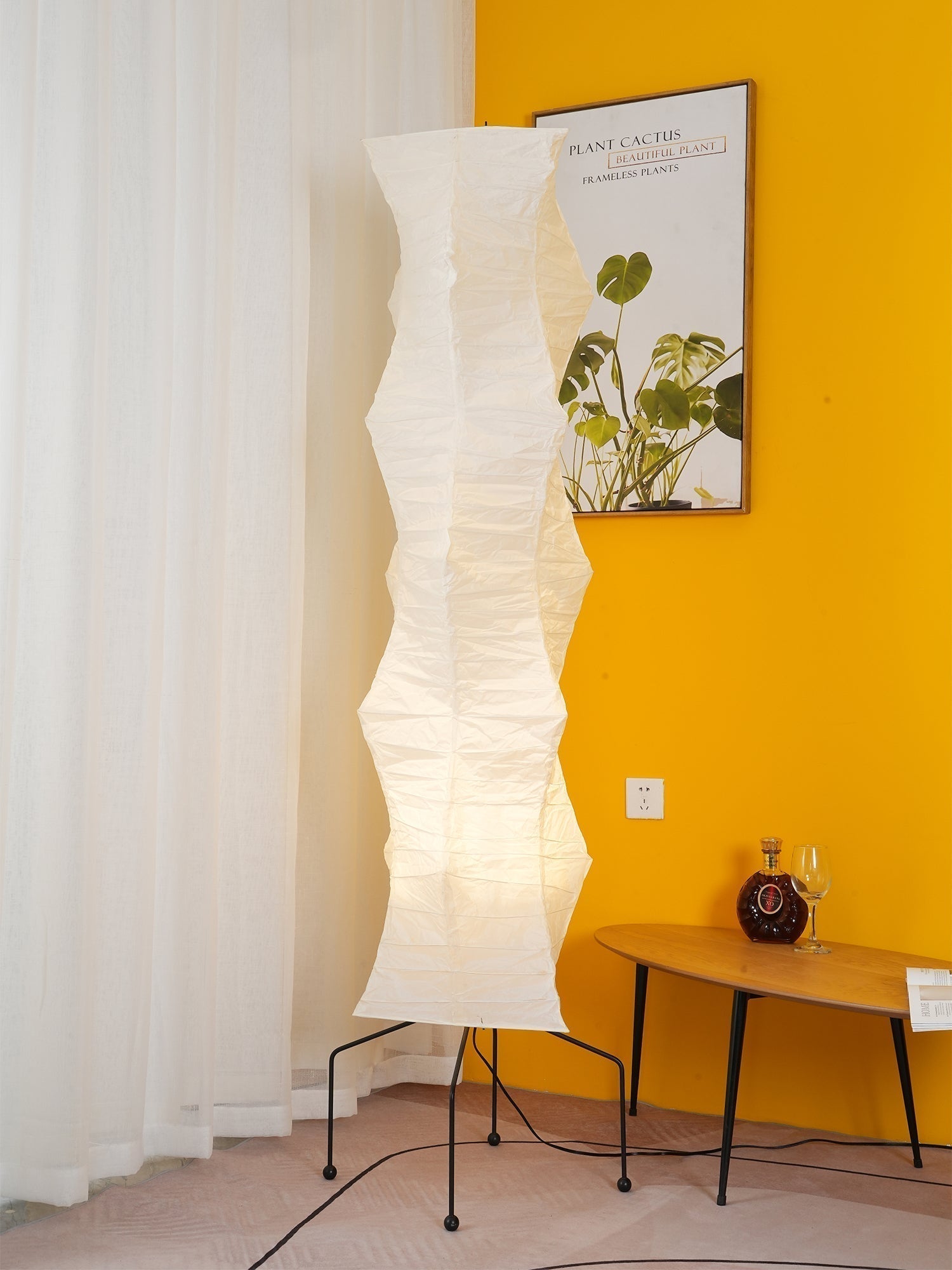 "Minimalist rice paper floor lamp with sleek metal frame and soft diffused light, perfect for creating a warm ambiance."