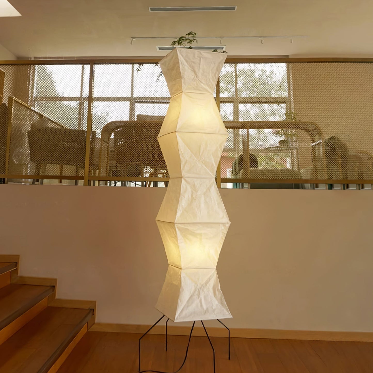 "Minimalist rice paper floor lamp with sleek metal frame and soft diffused light, perfect for creating a warm ambiance."