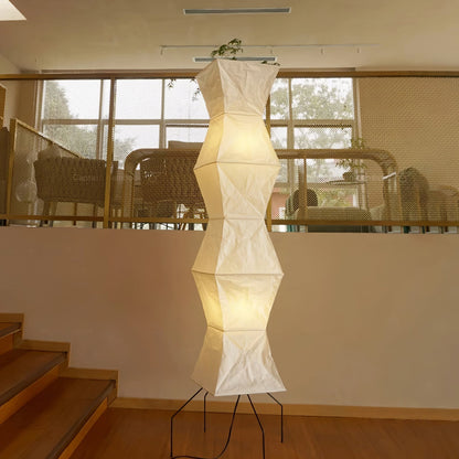 "Minimalist rice paper floor lamp with sleek metal frame and soft diffused light, perfect for creating a warm ambiance."