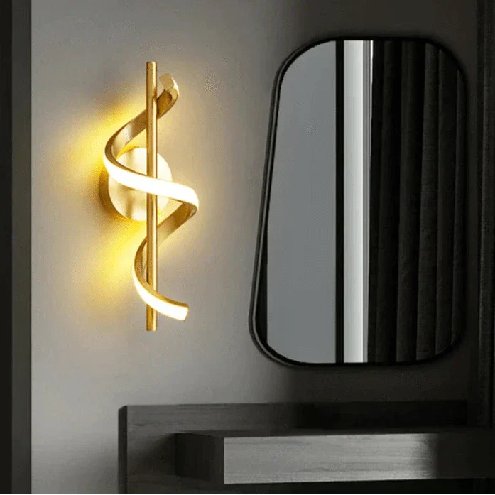 Modern LED wall sconce with adjustable gold arm and copper finish, ideal for ambient lighting in living rooms and bedrooms.