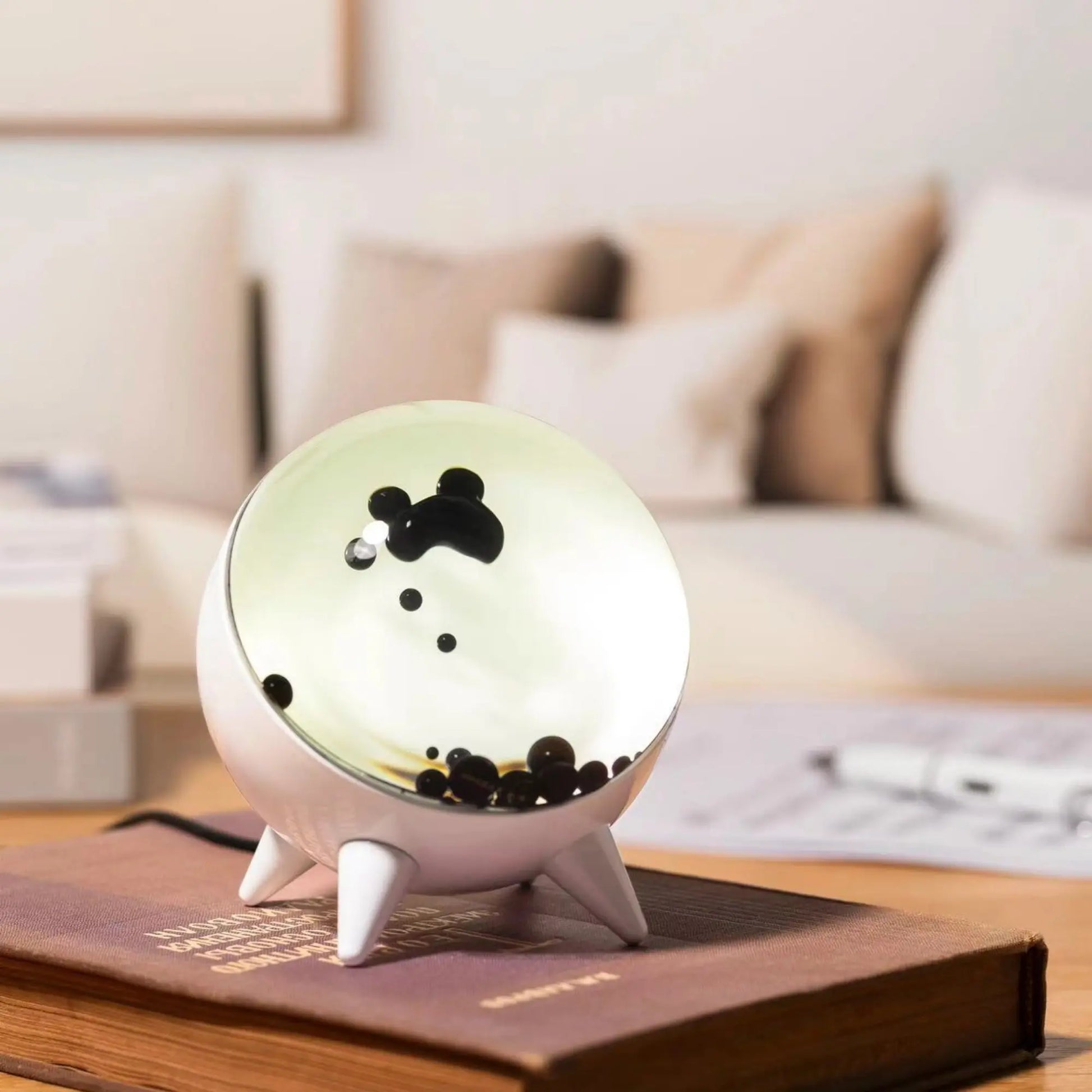"Music-reactive ferrofluid display with black fluid art in motion, Bluetooth connectivity, and built-in lighting for tech lov