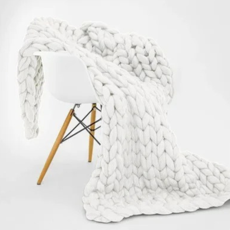 "Organic cotton weighted blanket in grey, offering cozy warmth and therapeutic pressure for all seasons. Available in multipl