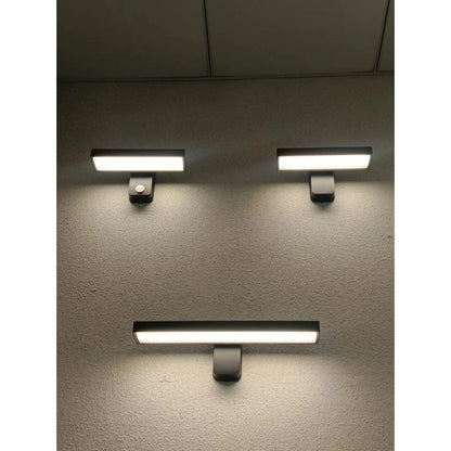 "Outdoor PIR motion sensor wall light, black aluminium, IP65 waterproof, rotatable design, warm white glow, modern style."