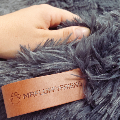 "Plush apricot donut dog bed, anxiety-relieving, round with raised rim, faux fur, for dogs to curl up comfortably."