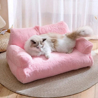 Plush cat sofa bed in pink, featuring soft material and raised edges for feline comfort and style, perfect for pet relaxation