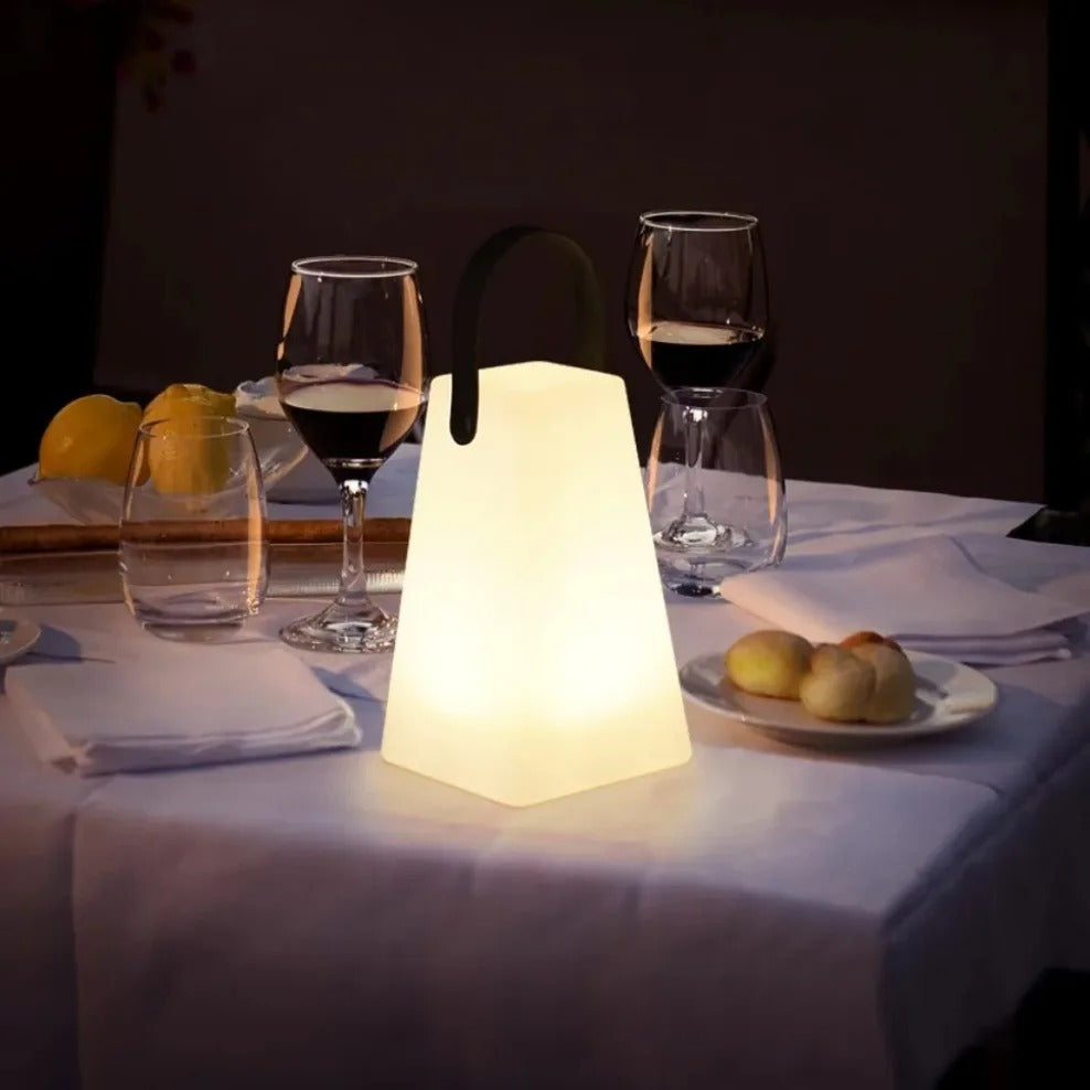 Portable waterproof cordless lamp with remote control, sleek modern design, suitable for indoor and outdoor lighting.