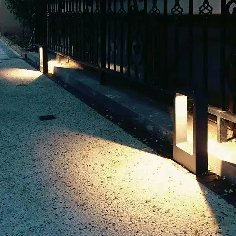 "Sleek aluminium outdoor garden light, weatherproof IP68 design, available in black or grey, enhances patios and pathways."
