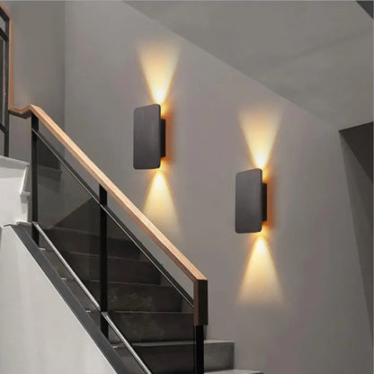 "Sleek indoor LED wall lamp with a modern rectangular design, featuring smooth finishes and warm illumination for elegant dec