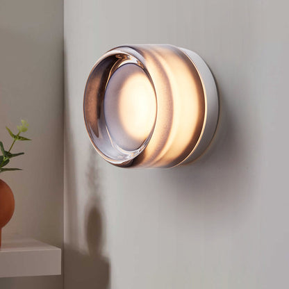 "Sleek wall mounted LED sconce light with acrylic and aluminum design, offering versatile decor enhancement for modern interi