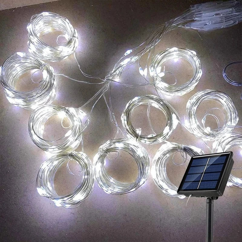 "Solar LED curtain light with copper wire, ideal for events, featuring warm white LEDs and solar power, outdoor use."