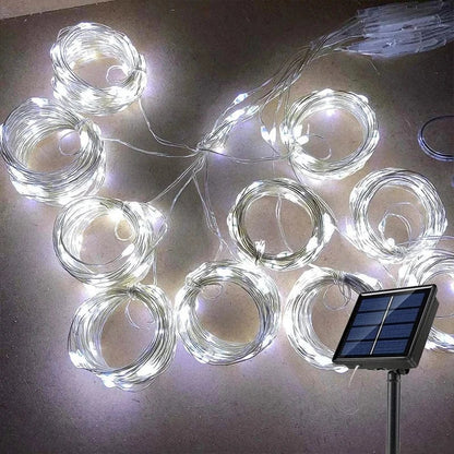 "Solar LED curtain light with copper wire, ideal for events, featuring warm white LEDs and solar power, outdoor use."