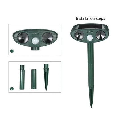 Solar-powered ultrasonic deer repeller with green casing, motion sensor, solar panel, ideal for outdoor garden protection.
