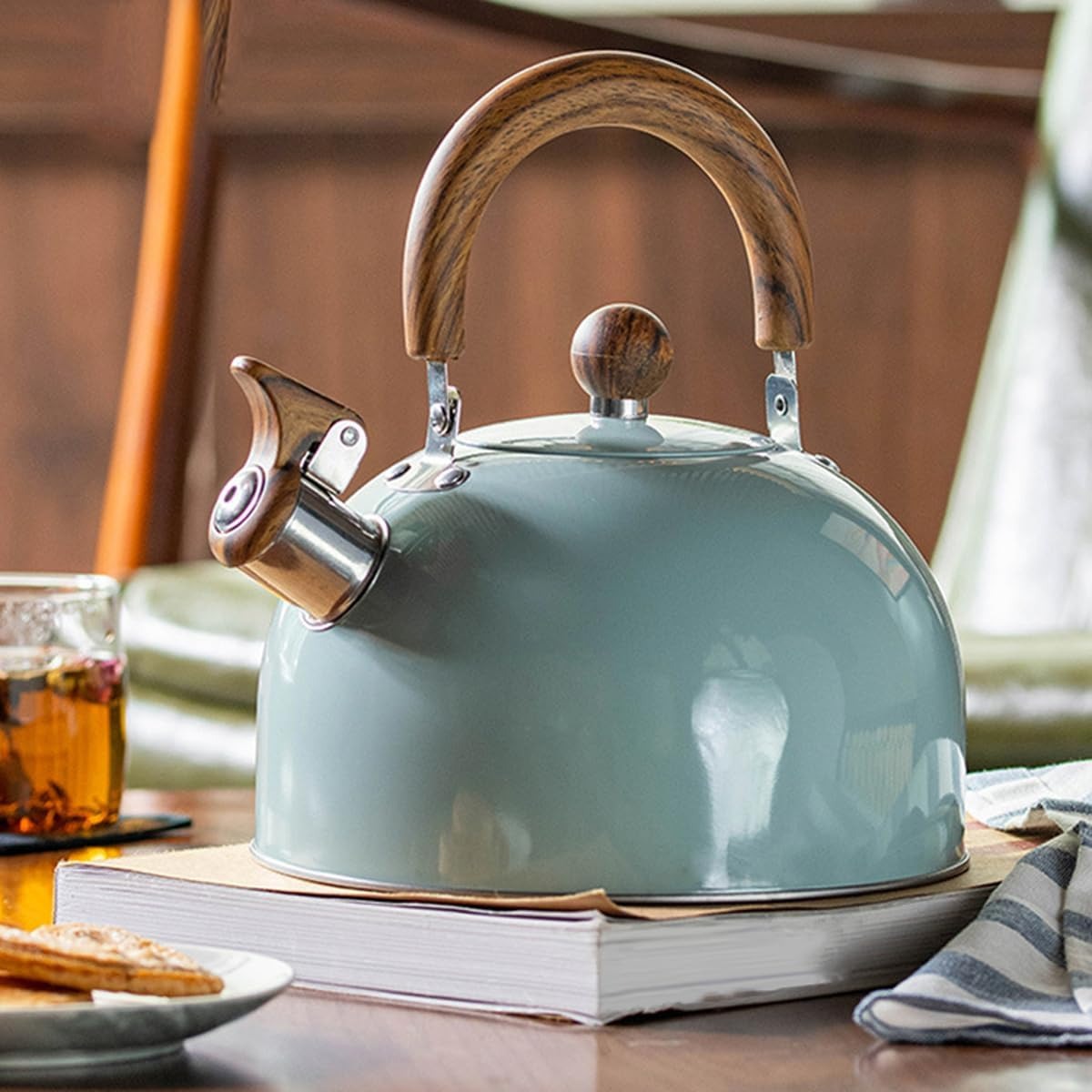 "Stainless steel whistling kettle with insulated handle, sleek design; kitchen essential for all stovetops, 3L capacity."