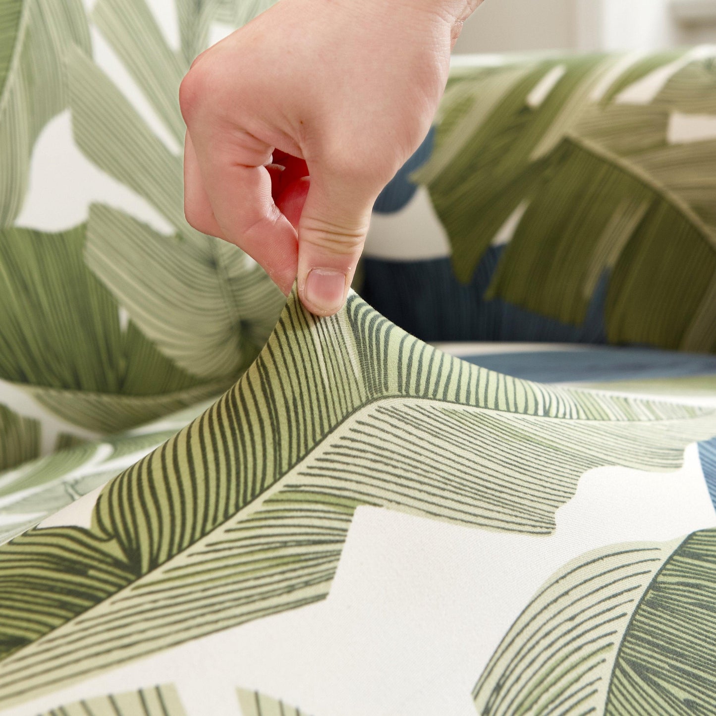 "Stretchy Split Leaf sofa cover with nature-inspired pattern fits various sofas, adds style, and offers protection against sp