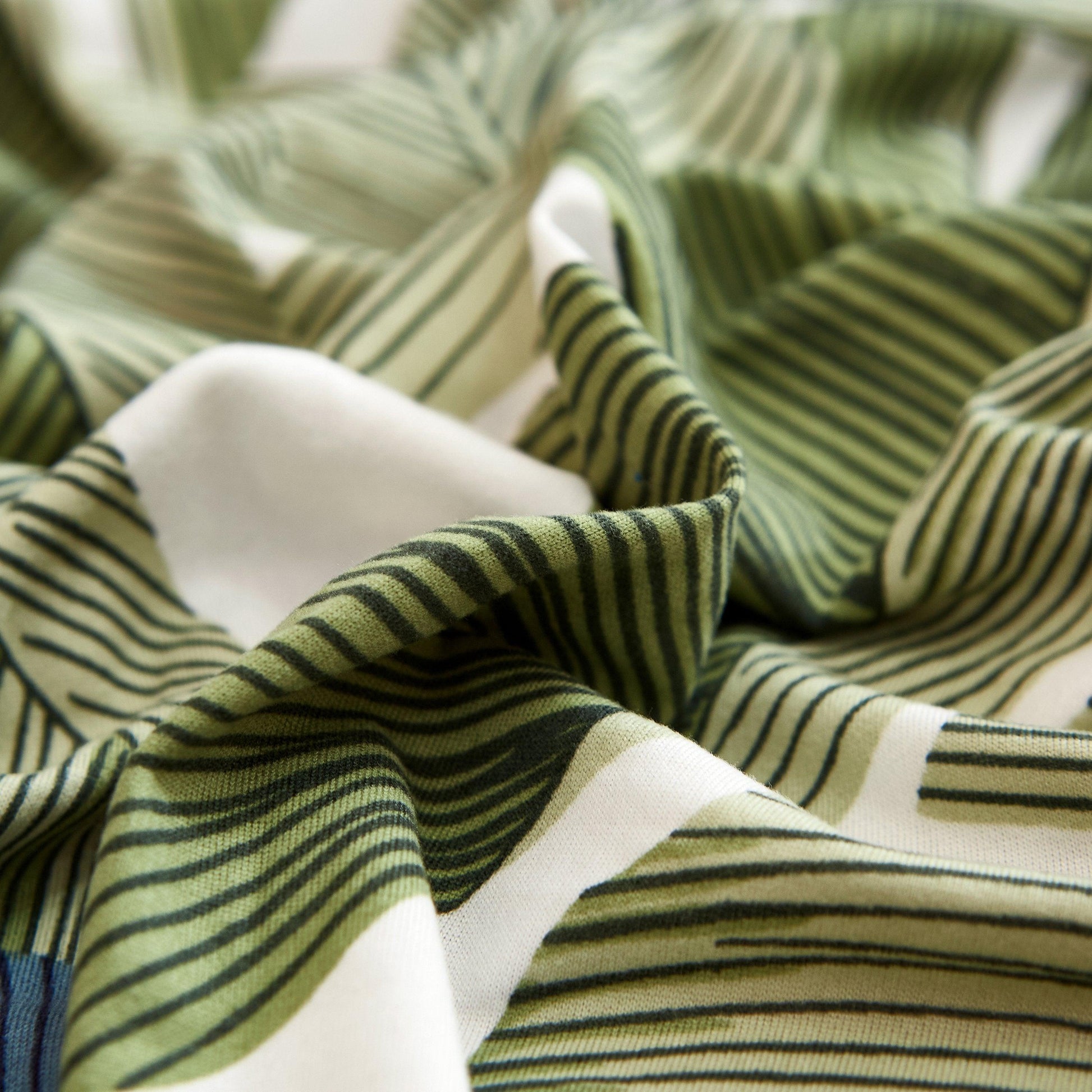 "Stretchy Split Leaf sofa cover with nature-inspired pattern fits various sofas, adds style, and offers protection against sp
