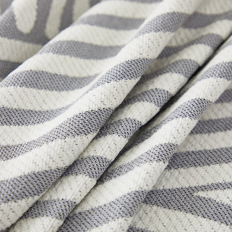 "Striped sofa throw cover, durable stretchable fabric, minimalist pattern, elevates living space, protects against spills."
