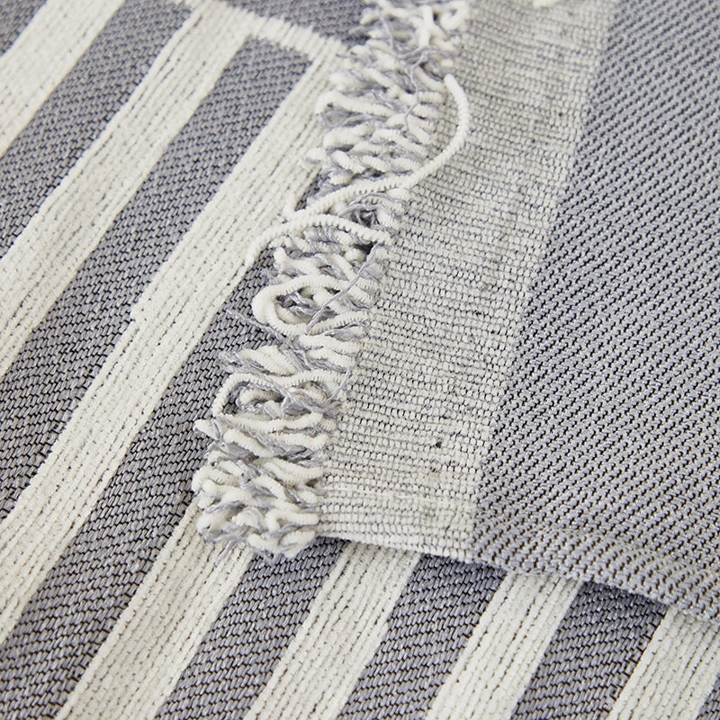 "Striped sofa throw cover, durable stretchable fabric, minimalist pattern, elevates living space, protects against spills."
