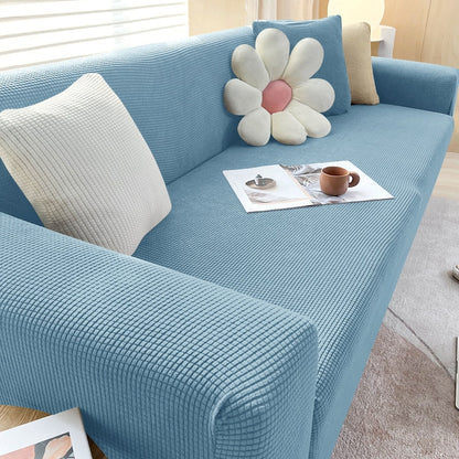 "Textured stretch sofa cover in beige, snug fit for sofas, non-slip, adds elegance, protects against spills and wear."
