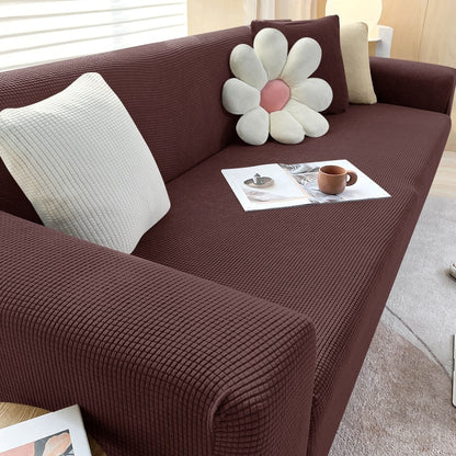 "Textured stretch sofa cover in beige, snug fit for sofas, non-slip, adds elegance, protects against spills and wear."
