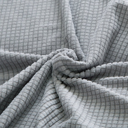 "Textured stretch sofa cover in beige, snug fit for sofas, non-slip, adds elegance, protects against spills and wear."
