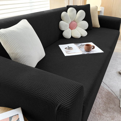 "Textured stretch sofa cover in beige, snug fit for sofas, non-slip, adds elegance, protects against spills and wear."