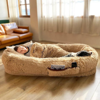 "Ultra-comfy plush lounger for pets and humans, oversized with plush pillow bolsters, dual-layer memory foam, stylish design.