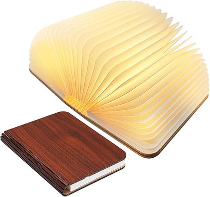 "Whimsical LED book lamp with warm glow, resembling an open book, perfect for cozy decor in bedrooms or study areas."