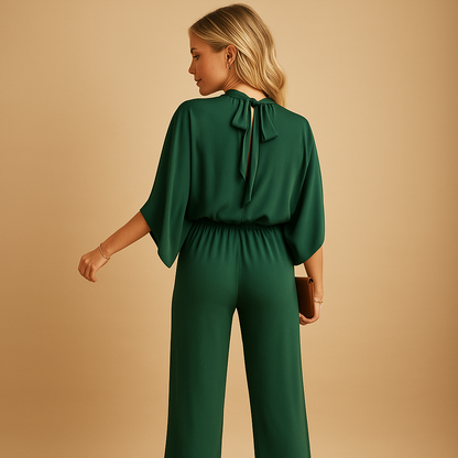 Women’s green wide-leg jumpsuit with long sleeves and relaxed fit, perfect for casual looks or formal occasions.