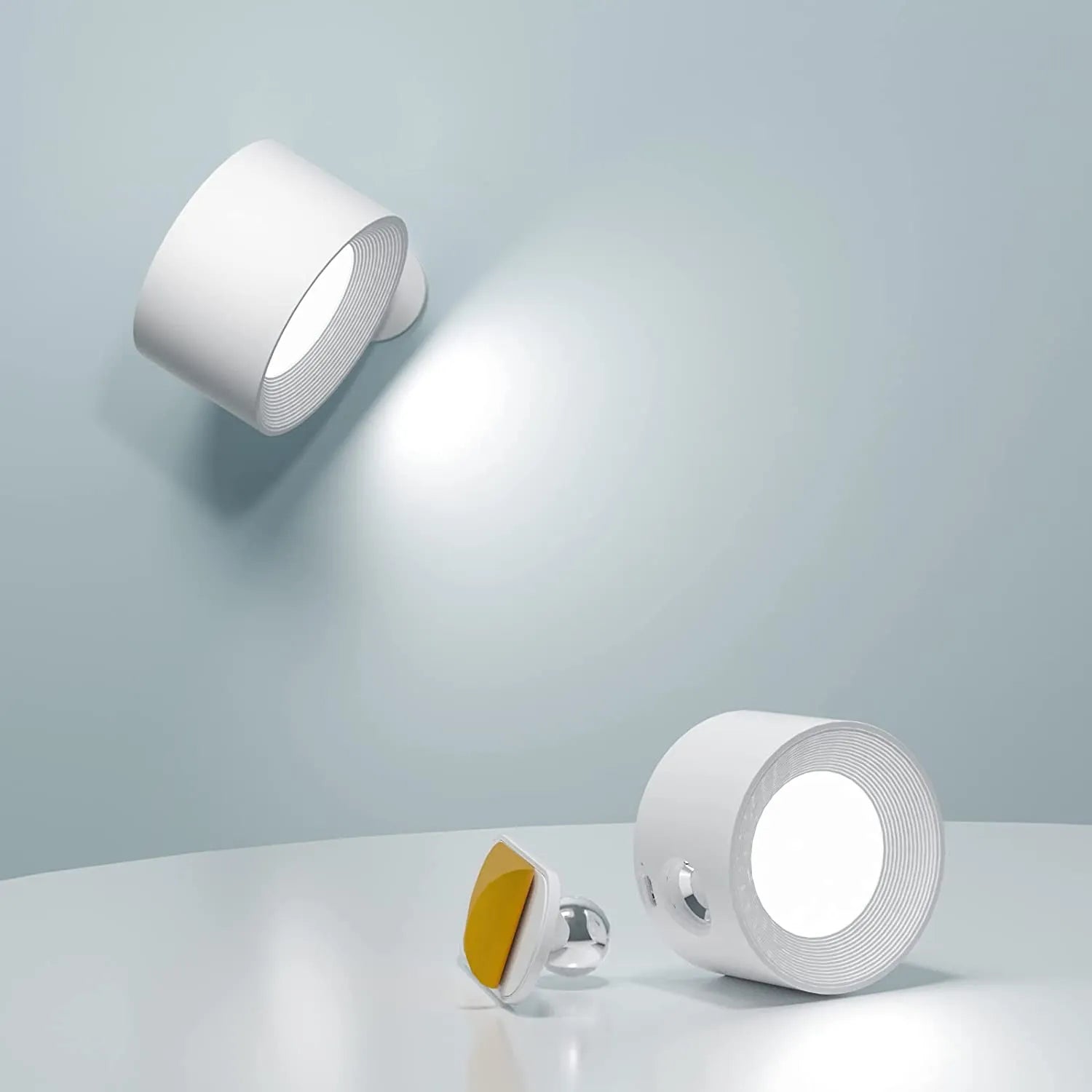 Wireless LED wall light, stick-on, black and white, cordless, for indoor and outdoor use, emits warm white glow, energy-effic