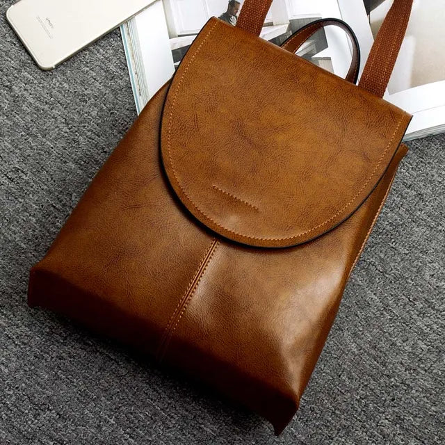 "Women's chic leather backpack, minimalist design, high-quality leather, adjustable straps, versatile for work and travel."