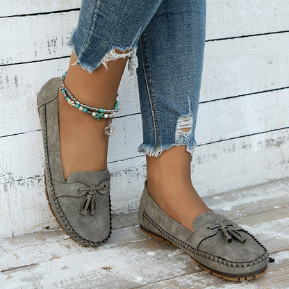 "Women's classic bow loafers in soft suede, stylish flat slip-ons with elegant bow accent, ideal for any occasion."