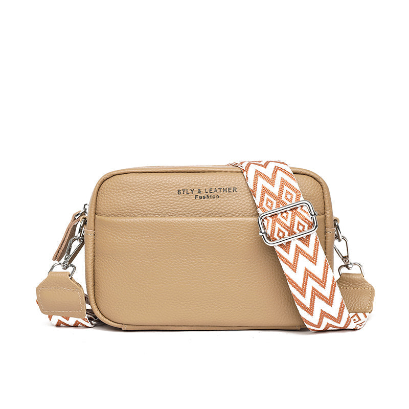"Women's elegant beige leather crossbody bag with pebbled texture and adjustable strap, perfect for versatile fashion styling