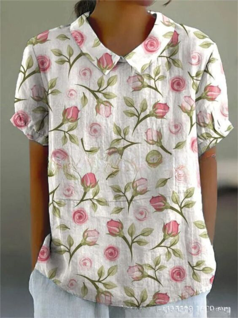 Women's elegant floral blouse with short sleeves and Peter Pan collar, featuring a vibrant floral pattern for stylish summer 