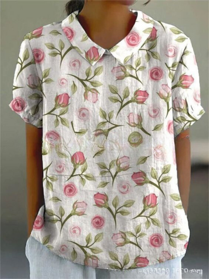 Women's elegant floral blouse with short sleeves and Peter Pan collar, featuring a vibrant floral pattern for stylish summer 