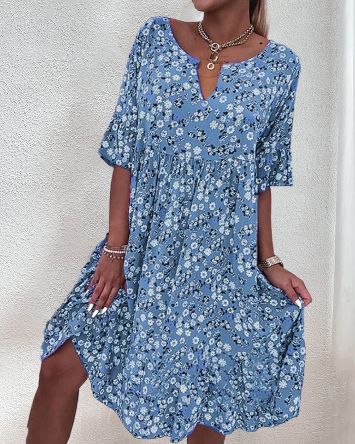 Women's elegant floral V-neck midi dress, vibrant pattern, flattering fit, perfect for garden parties and casual outings.