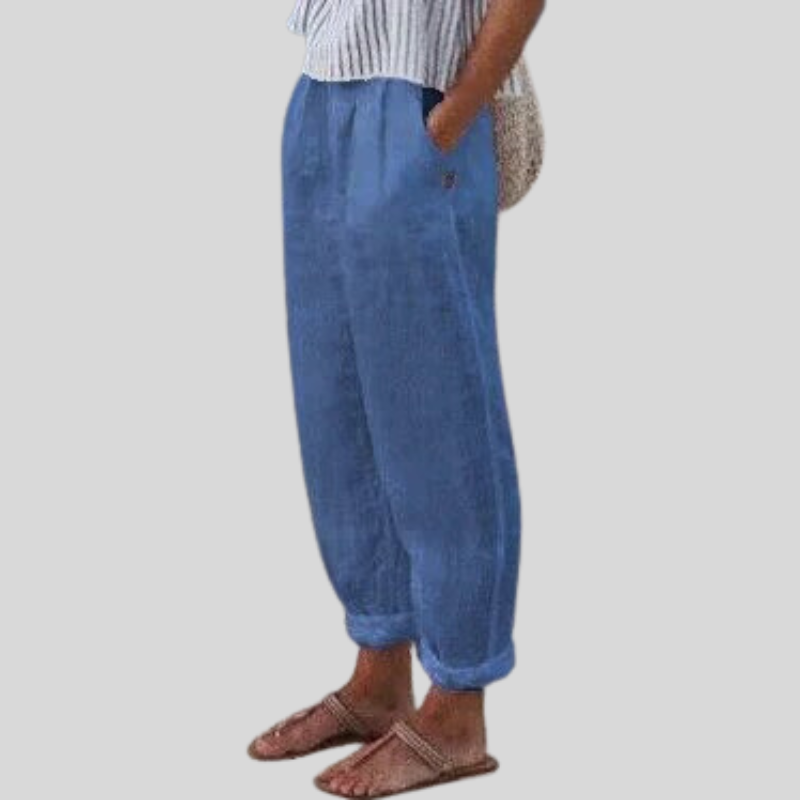 "Women's linen trousers with folded hem, relaxed fit; lightweight, breathable fabric, beige tones, tailored style."