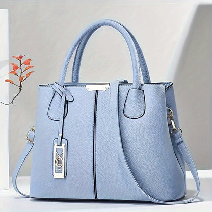 Women's stylish leather handbag with tote design, detachable crossbody strap, gold accents, spacious interior, elegant look.