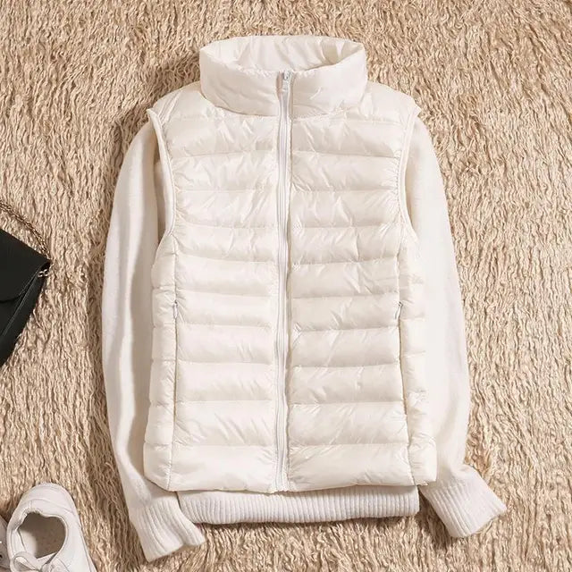 Women's ultra light down vest, warm, lightweight, sleeveless in sleek design, ideal for layering, perfect for chilly days.
