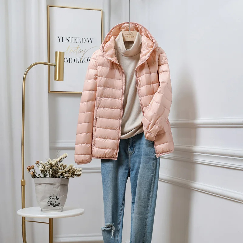 "Women's ultralight foldable puffer jacket with hood, chic design, lightweight, perfect for travel and cold weather."