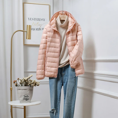 "Women's ultralight foldable puffer jacket with hood, chic design, lightweight, perfect for travel and cold weather."