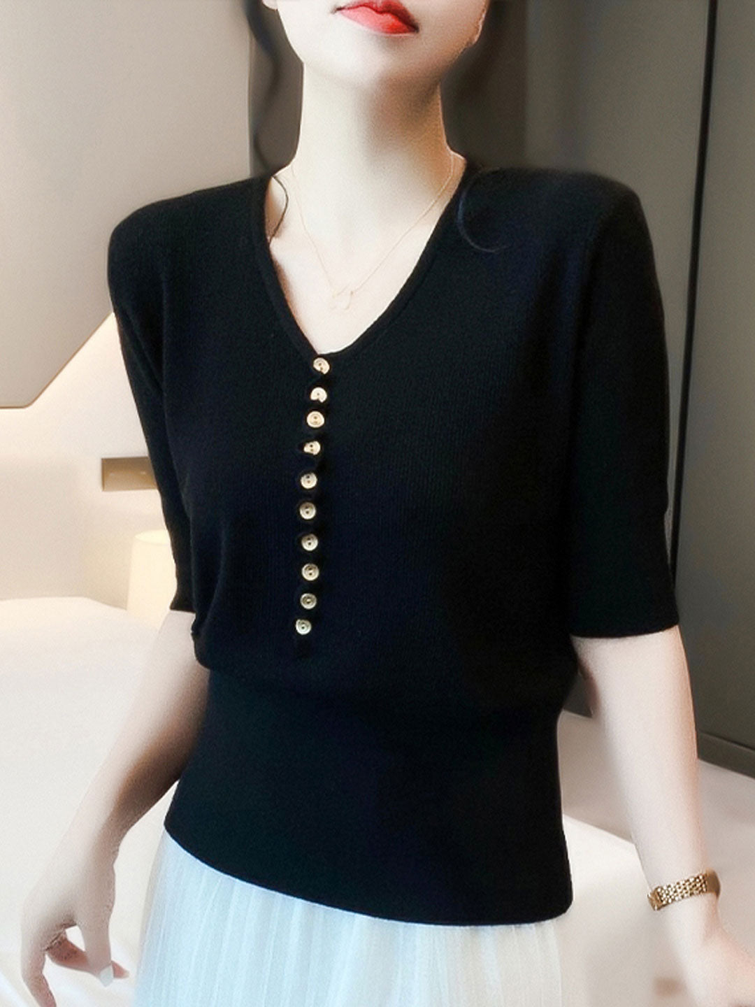 "Women's V-neck button knitted top with relaxed fit, shown in vibrant colors, offering style and comfort for any occasion."