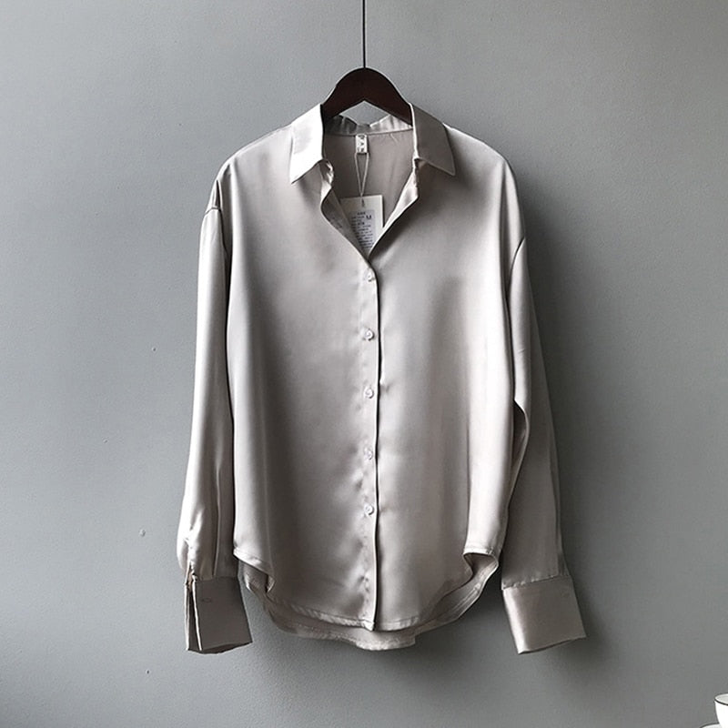 Women's vintage silk blouse with tailored fit, chic design, elegant silhouette, and luxurious lightweight fabric.