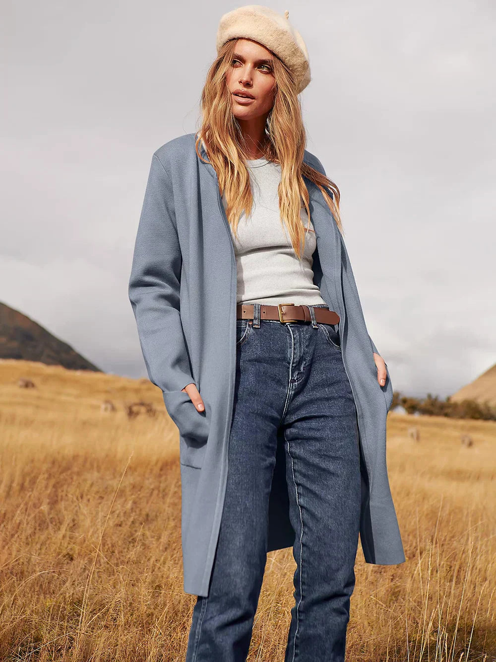 "Women's wool blend knee-length coat with wide lapel and patch pockets, showcasing a relaxed fit and minimalist design."